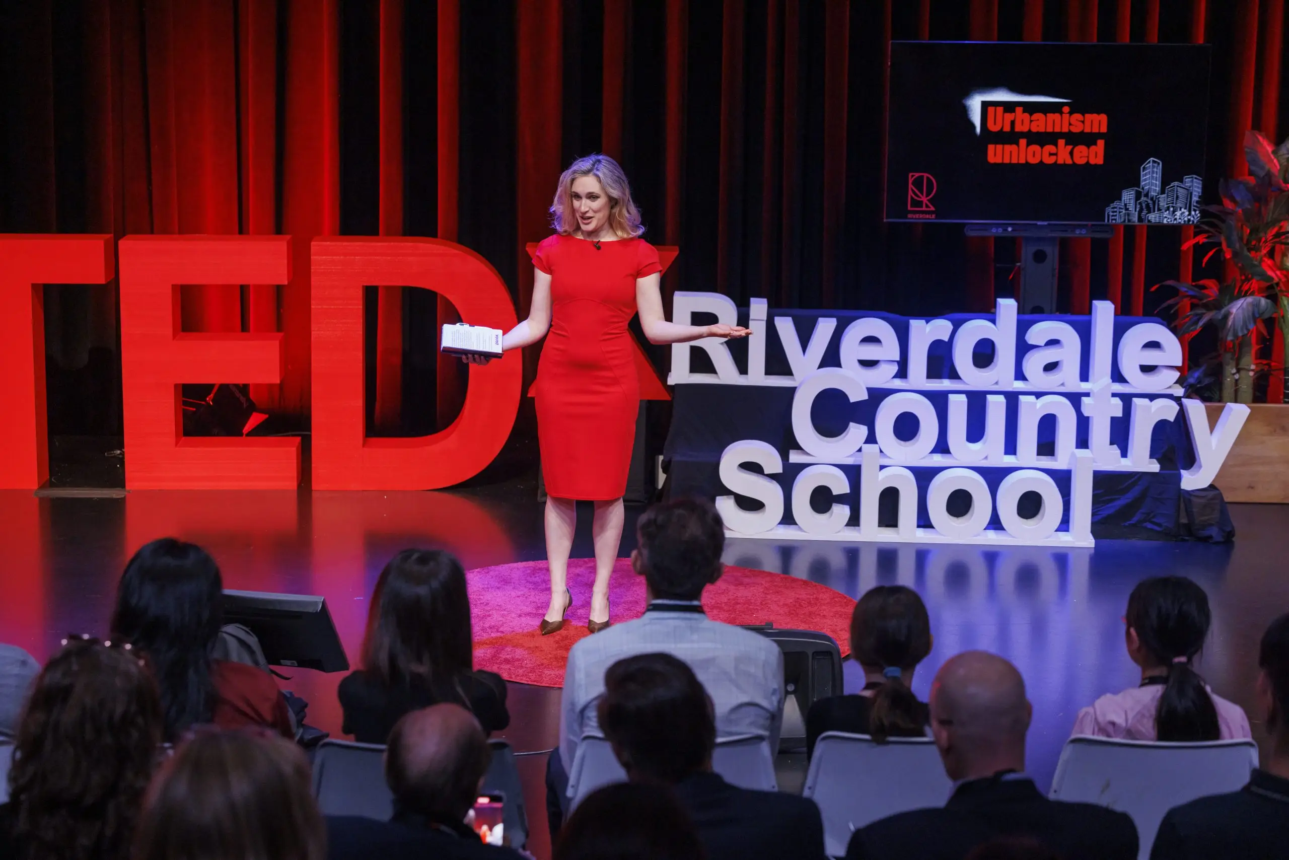Rachel Duval speaking on stage at TEDx Riverdale Country School